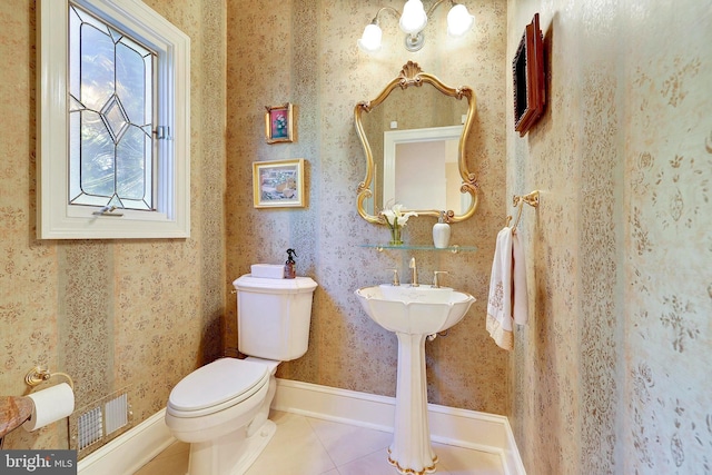 half bathroom featuring visible vents, tile patterned floors, toilet, and wallpapered walls
