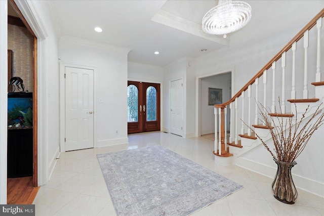 foyer with baseboards, ornamental molding, light tile patterned floors, and stairway