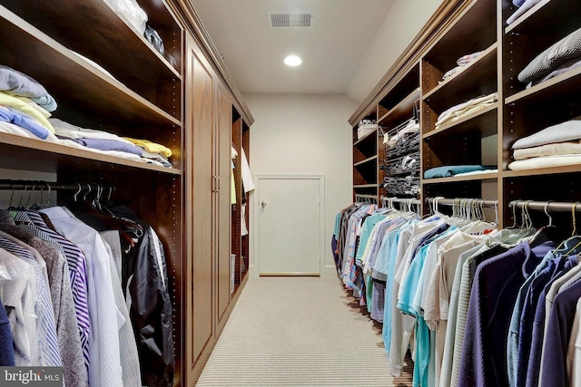 spacious closet with carpet flooring and visible vents