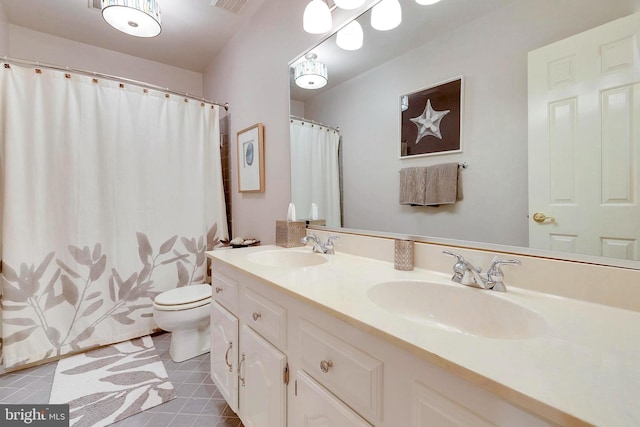 full bath featuring double vanity, toilet, tile patterned floors, and a sink
