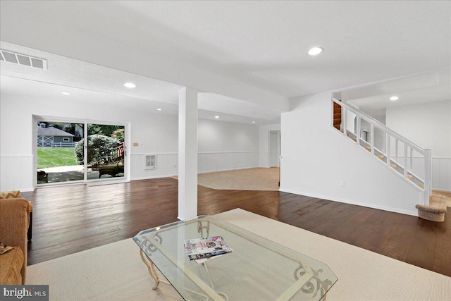 interior space featuring stairway, wood-type flooring, recessed lighting, and visible vents