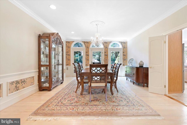 dining area with a chandelier, light wood-style flooring, recessed lighting, baseboards, and ornamental molding