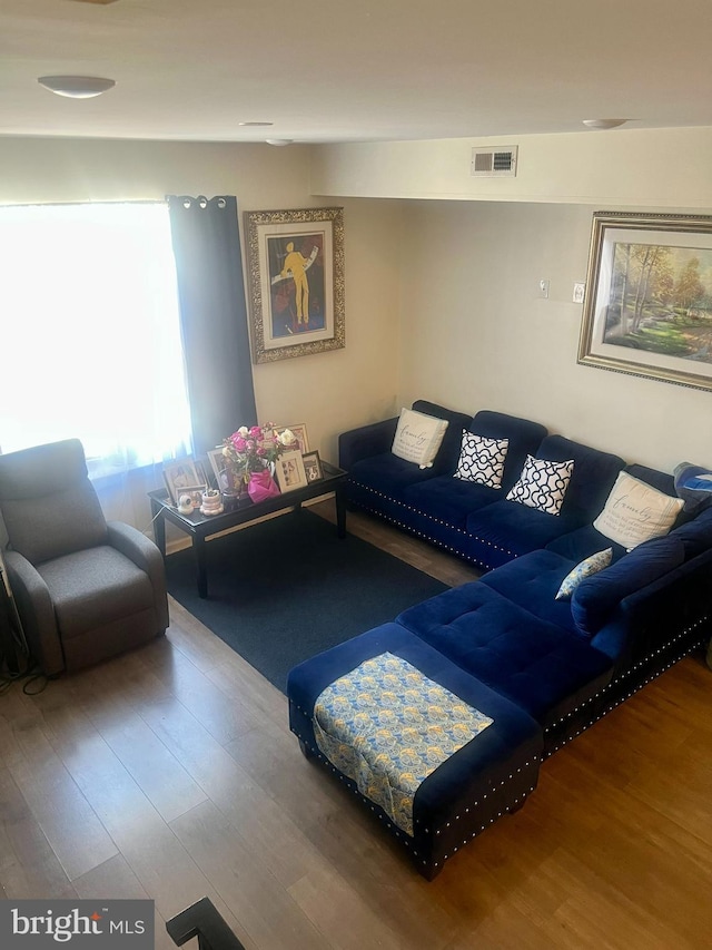 living area featuring wood finished floors and visible vents