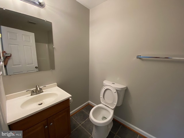 bathroom featuring visible vents, tile patterned floors, baseboards, vanity, and toilet