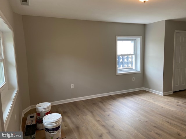unfurnished room with baseboards and wood finished floors