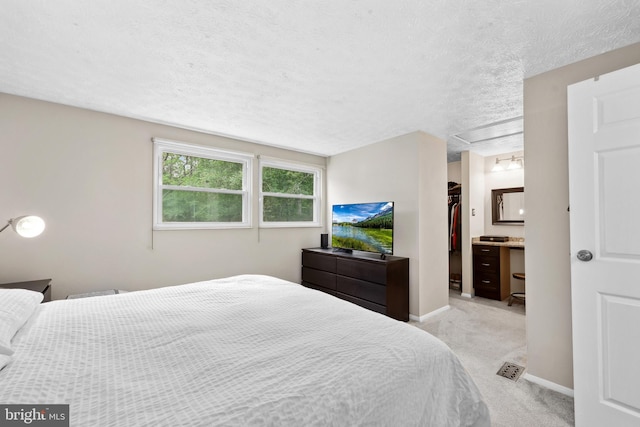 8140 Willowdale Ct, Springfield, VA 22153 - bedroom with a walk in closet, carpet, a textured ceiling, a closet, and baseboards