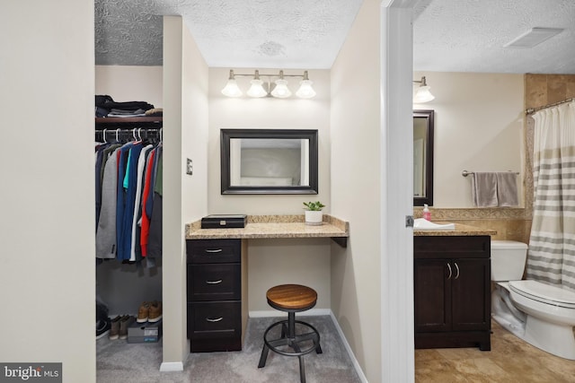 8140 Willowdale Ct, Springfield, VA 22153 - bathroom with toilet, vanity, a textured ceiling, a spacious closet, and a shower with curtain