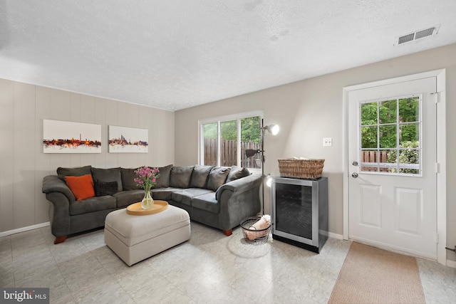 8140 Willowdale Ct, Springfield, VA 22153 - living area featuring a textured ceiling, baseboards, and beverage cooler