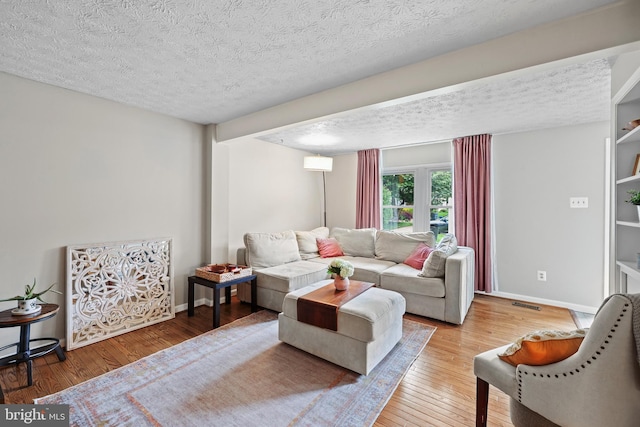 8140 Willowdale Ct, Springfield, VA 22153 - living room featuring a textured ceiling, hardwood / wood-style flooring, and baseboards