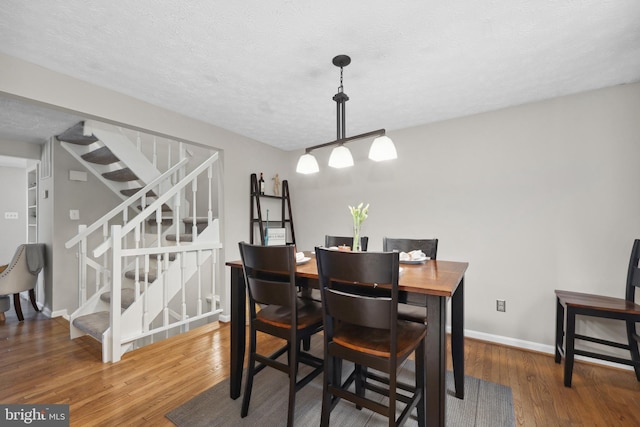 8140 Willowdale Ct, Springfield, VA 22153 - dining area with stairs, wood finished floors, baseboards, and a textured ceiling