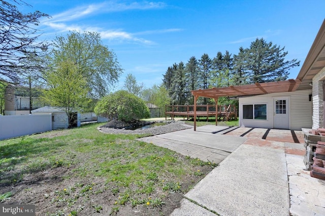 view of yard with a patio area, fence, a pergola, and a wooden deck