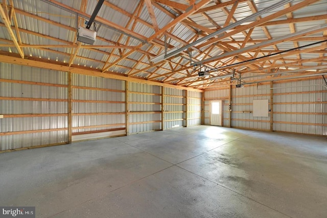 garage with a garage door opener and metal wall