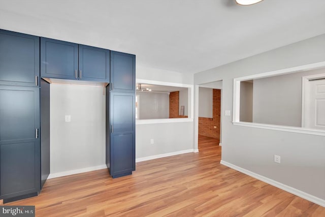 interior space featuring baseboards and light wood-type flooring