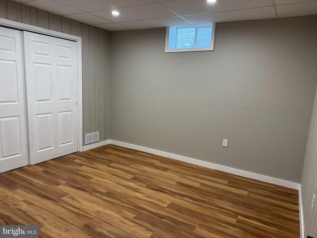 unfurnished bedroom with baseboards, wood finished floors, visible vents, and a closet