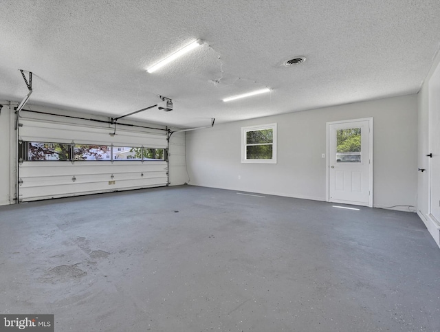 garage featuring visible vents and a garage door opener
