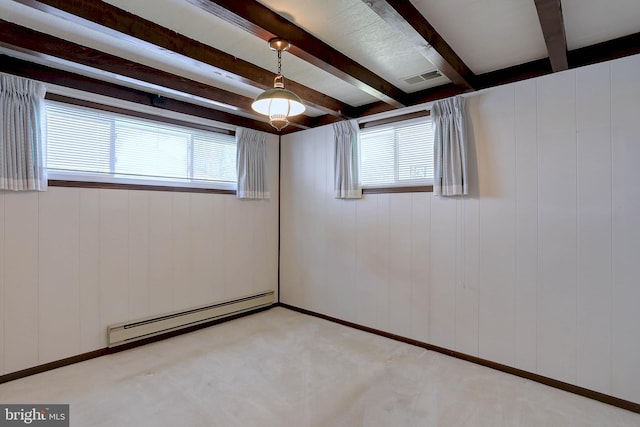 unfurnished room featuring beamed ceiling, plenty of natural light, baseboard heating, and light carpet