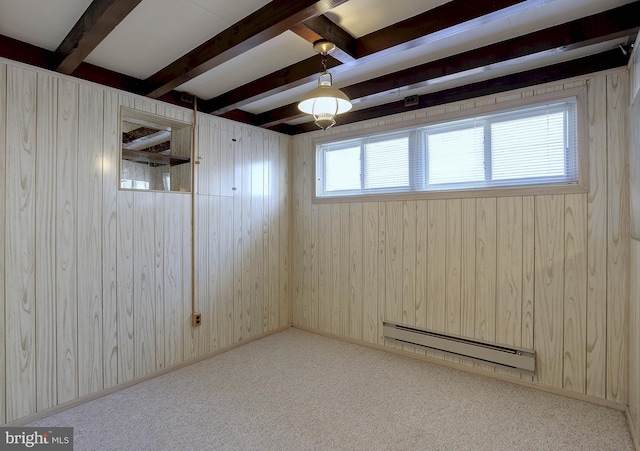 basement with carpet floors, a baseboard radiator, and wooden walls