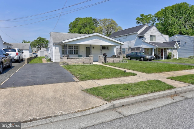 bungalow featuring a porch and a front yard