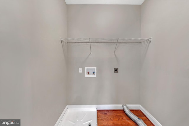 laundry room featuring laundry area, electric dryer hookup, wood finished floors, baseboards, and hookup for a washing machine