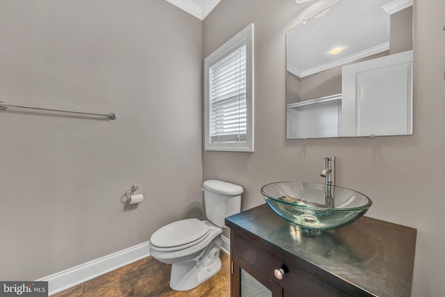 bathroom with toilet, baseboards, ornamental molding, and vanity