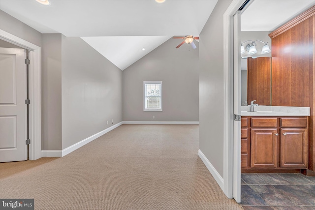 additional living space with a ceiling fan, baseboards, lofted ceiling, and dark colored carpet