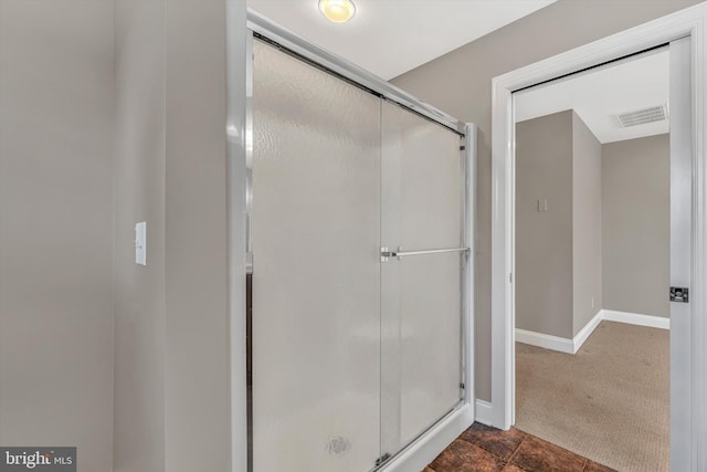 bathroom with visible vents, baseboards, and a shower stall