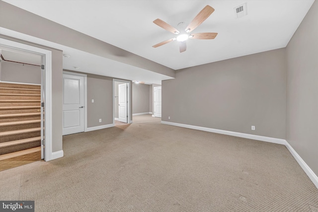 interior space featuring stairway, carpet floors, baseboards, and a ceiling fan