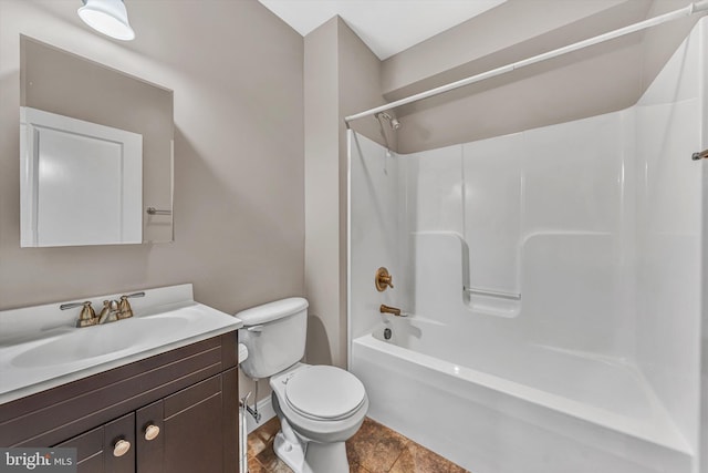 bathroom with vanity, baseboards, tub / shower combination, and toilet
