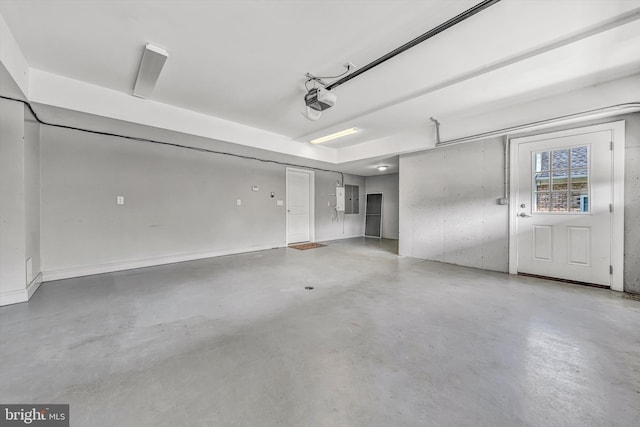 garage with a garage door opener and electric panel