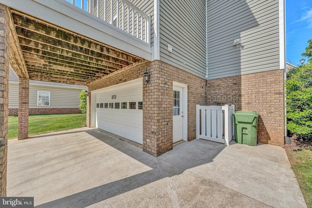 garage featuring concrete driveway