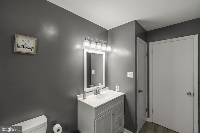 1004 Marietta Ave, Hanover, PA 17331 - half bathroom featuring toilet, vanity, and wood finished floors