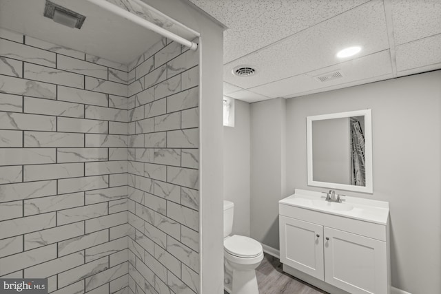 1004 Marietta Ave, Hanover, PA 17331 - full bath featuring vanity, toilet, a tile shower, and wood finished floors