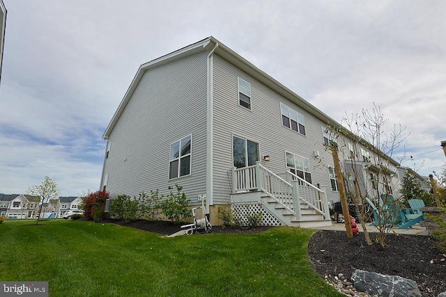 rear view of house featuring a yard