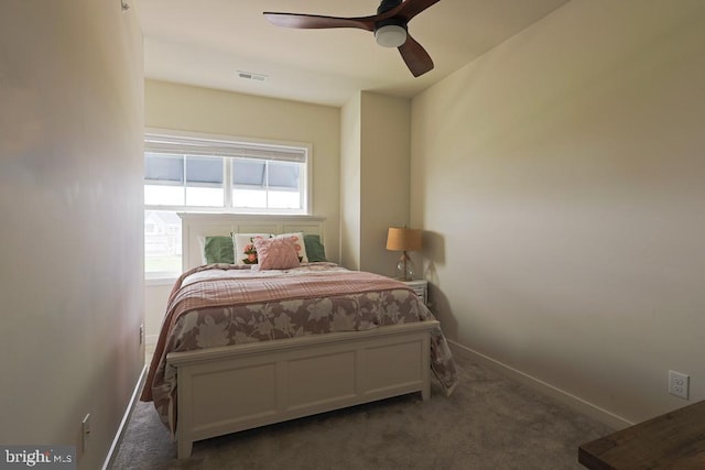carpeted bedroom with a ceiling fan, baseboards, and visible vents