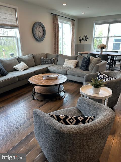 living area with recessed lighting, dark wood finished floors, and a wealth of natural light