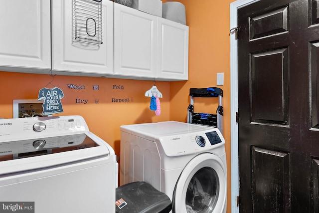 laundry area featuring cabinet space and washing machine and clothes dryer
