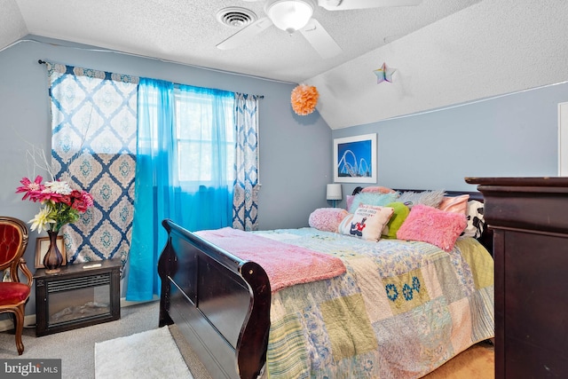 bedroom with a ceiling fan, a textured ceiling, visible vents, vaulted ceiling, and carpet floors