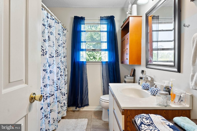 bathroom with vanity, tile patterned floors, toilet, and curtained shower