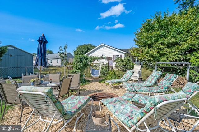 view of patio / terrace featuring a fire pit, fence, and outdoor dining space