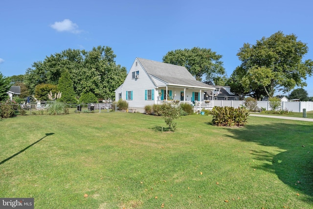 exterior space with fence, a porch, and a front yard
