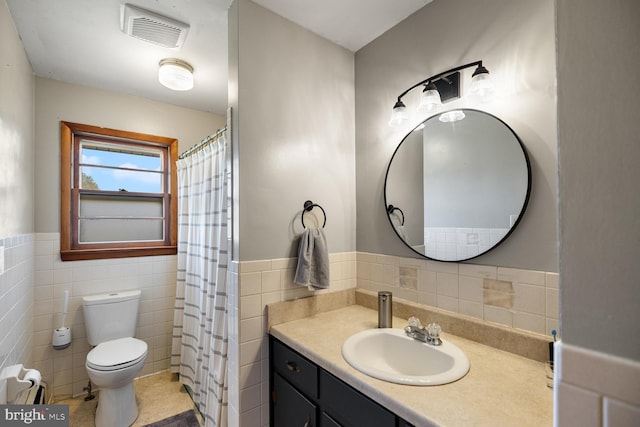 196 Taylortown Rd, Edinburg, VA 22824 - bathroom featuring tile walls, toilet, a wainscoted wall, vanity, and tile patterned flooring