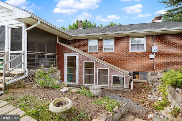 196 Taylortown Rd, Edinburg, VA 22824 - back of property featuring a chimney, brick siding, and a sunroom