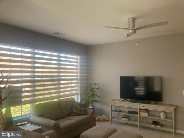 carpeted living area with ceiling fan and visible vents