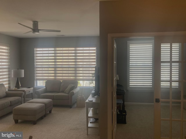 carpeted living room featuring a ceiling fan