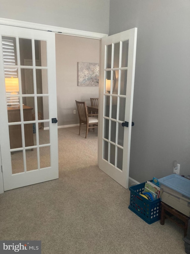 interior space featuring carpet floors, baseboards, and french doors
