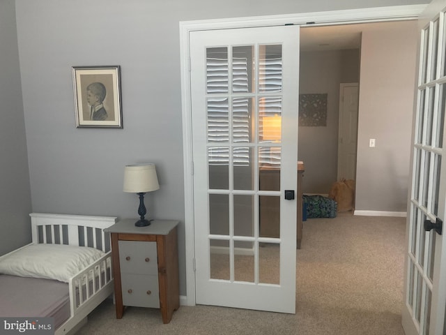bedroom featuring carpet floors, baseboards, and french doors