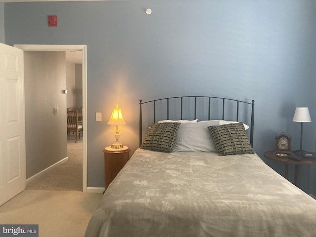 bedroom with baseboards and carpet