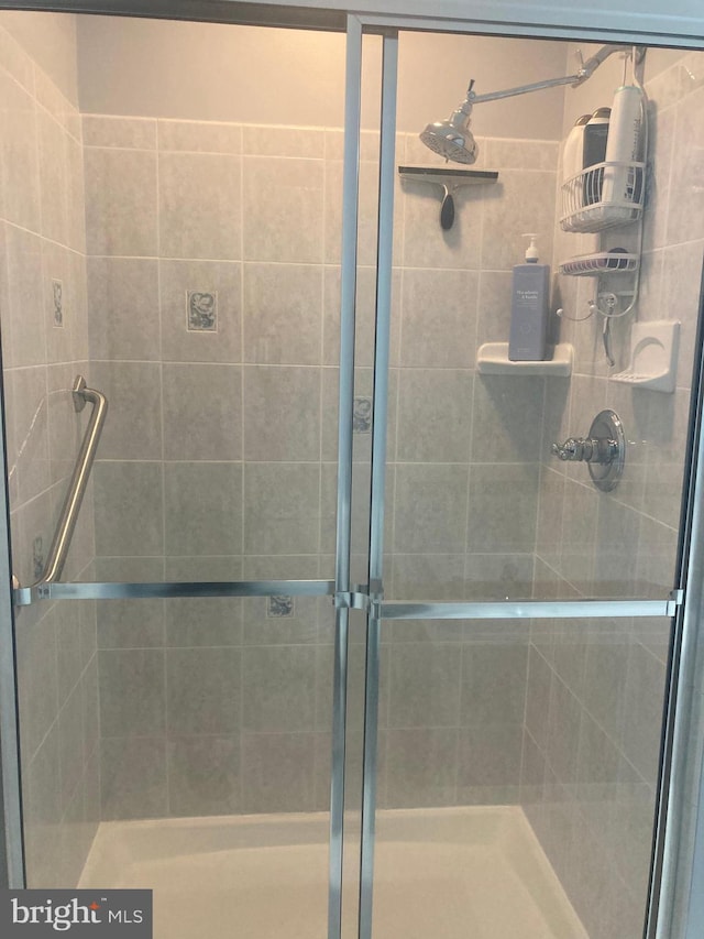 full bath with a shower stall