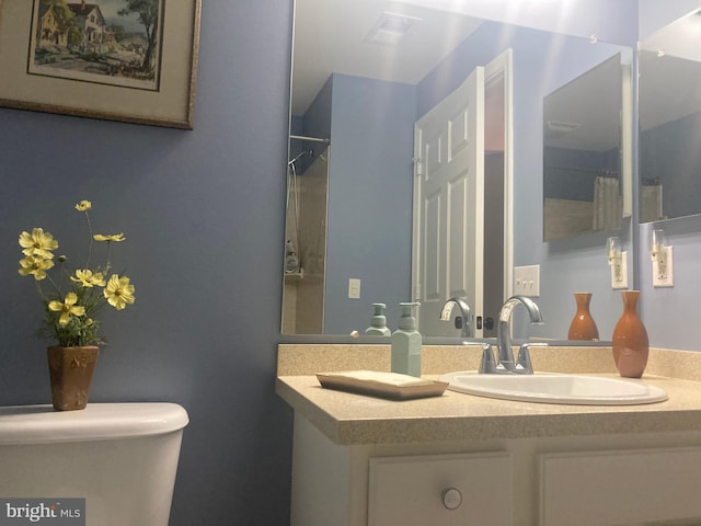 full bathroom featuring vanity and toilet