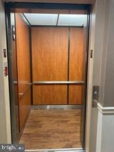 details featuring wood finished floors and elevator